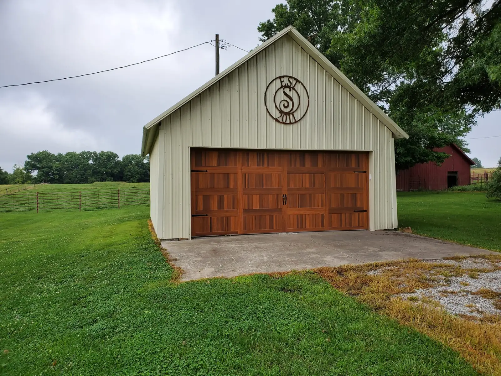 Cedar carriage-house garage door on a rural outbuilding