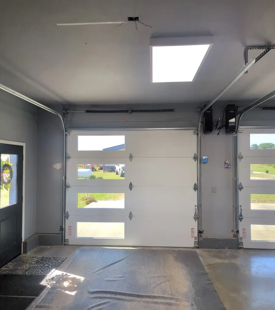 Garage door opener and rail installed above an overhead door
