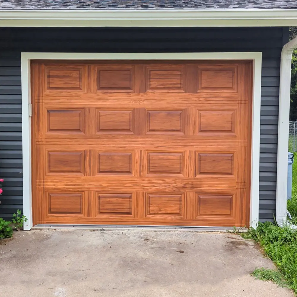 Cedar-finish residential garage door with raised square panels