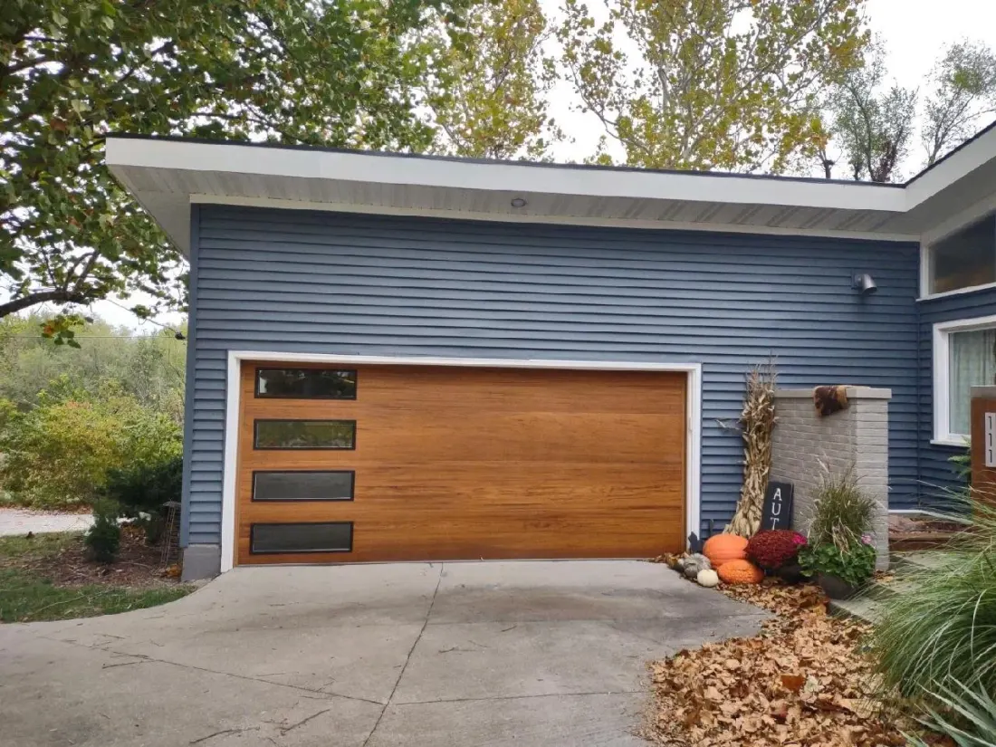 Modern flush cedar-finish garage door with stacked windows